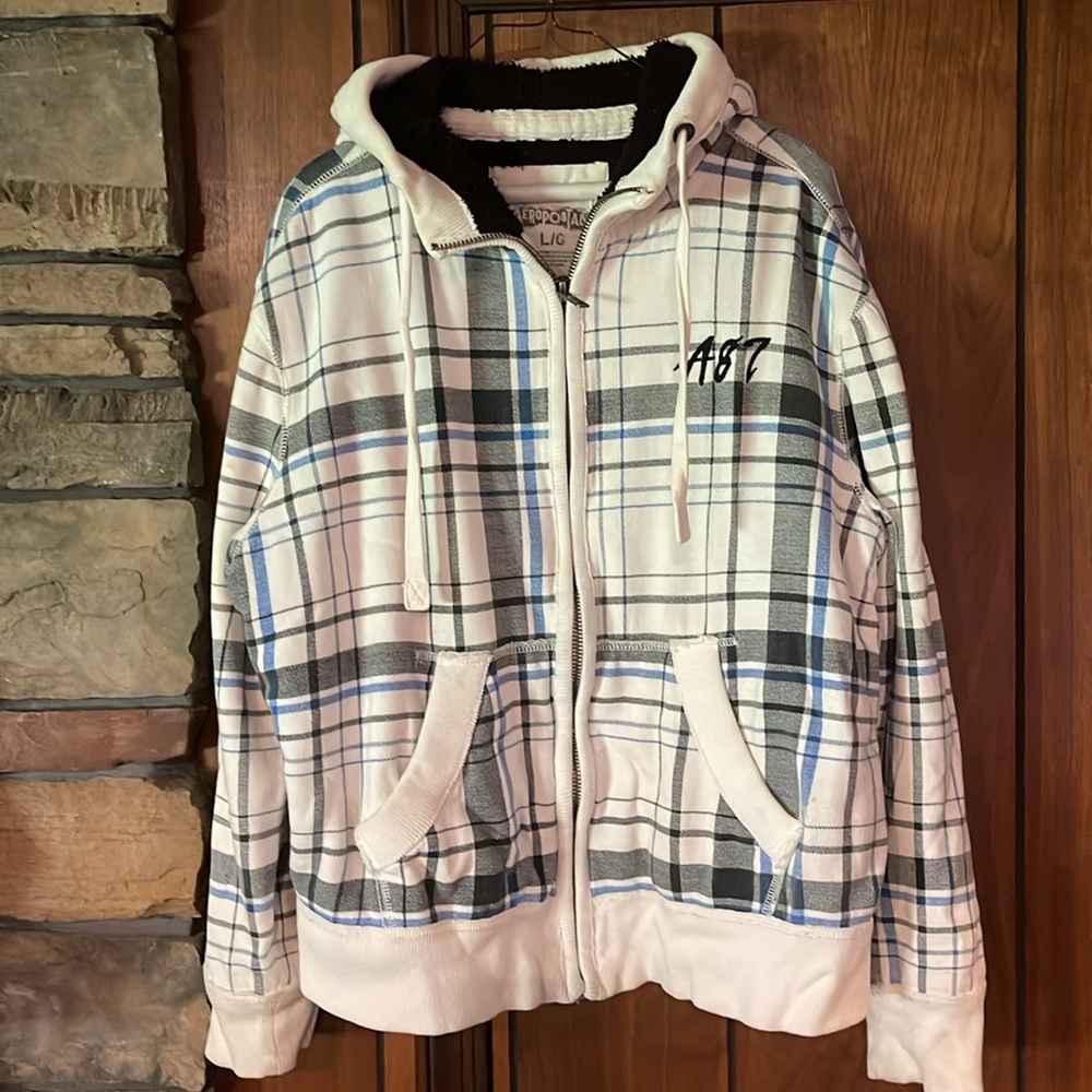 White zip up hoodie with blue and black accent